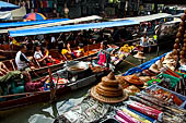 Thailand, Locals sell fruits, food and products at Damnoen Saduak floating market near Bangkok 